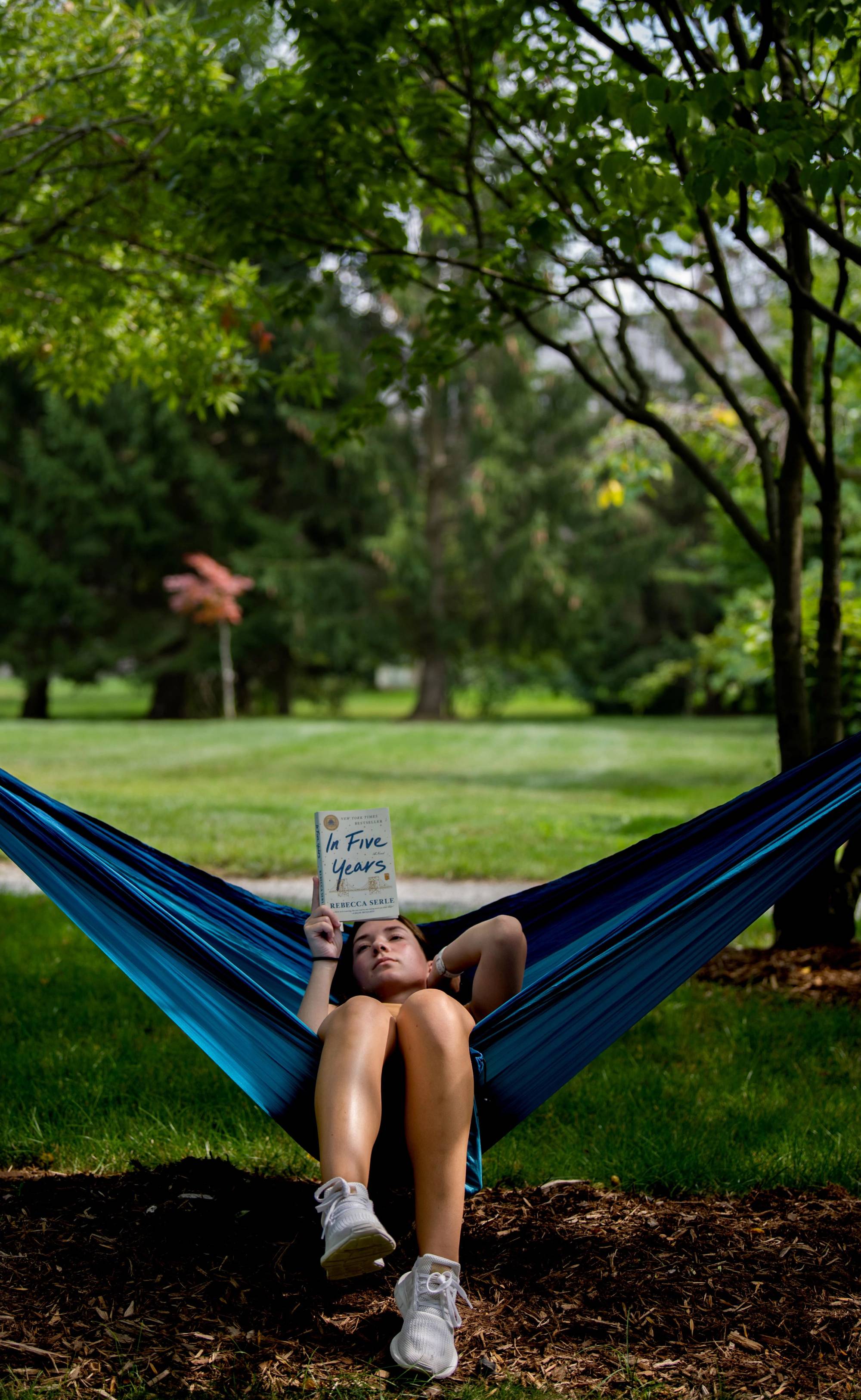Student reading in a hammock on campus